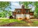 A view of the back of the house with brick exterior, showing the yard and surrounding greenery at 1913 Flintwood Se Dr, Atlanta, GA 30316