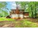 Back exterior of a brick house with a chimney and stairs leading to the second floor at 1913 Flintwood Se Dr, Atlanta, GA 30316