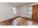 Bedroom featuring hardwood floors, two windows for natural light, and a wooden door at 1913 Flintwood Se Dr, Atlanta, GA 30316
