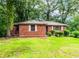 Traditional brick home with a well-maintained lawn and verdant landscaping, creating a welcoming atmosphere at 1913 Flintwood Se Dr, Atlanta, GA 30316