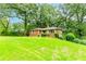 Quaint brick house nestled on a grassy hill, surrounded by mature trees offering privacy and a serene setting at 1913 Flintwood Se Dr, Atlanta, GA 30316