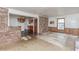 Open floor plan featuring a brick accent wall, a view into the kitchen, and natural light at 1913 Flintwood Se Dr, Atlanta, GA 30316