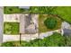 Aerial view of a home showing the driveway, roof, and backyard with mature trees and green grass at 2021 Sherwood Dr Se, Marietta, GA 30062