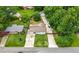 Aerial view shows a beautiful tree-lined backyard, driveway and detached garage at 2021 Sherwood Dr Se, Marietta, GA 30062