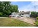 Backyard view with white siding home, picnic table and lush grass at 2021 Sherwood Dr Se, Marietta, GA 30062
