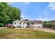 Backyard view with white siding home, picnic table and lush grass at 2021 Sherwood Dr Se, Marietta, GA 30062