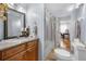 Bathroom boasts a granite vanity and a shower with decorative curtain at 2021 Sherwood Dr Se, Marietta, GA 30062