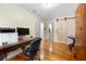 Bedroom with hardwood floors features a barn door and an office space with a desk and computer at 2021 Sherwood Dr Se, Marietta, GA 30062