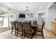 Dining area with a large table, modern lighting, sliding glass doors, and light-colored walls at 2021 Sherwood Dr Se, Marietta, GA 30062