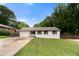 Charming single-story home with a well-manicured lawn and a driveway leading to an attached garage at 2021 Sherwood Dr Se, Marietta, GA 30062