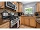 Modern kitchen featuring stainless steel appliances, custom cabinets, granite counters, and a stylish backsplash at 2021 Sherwood Dr Se, Marietta, GA 30062
