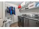 Laundry room has front load washer and dryer with storage shelves and rod at 2021 Sherwood Dr Se, Marietta, GA 30062