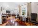 Cozy living room with hardwood floors, recessed lighting, large windows, couches, and other stylish furniture at 2021 Sherwood Dr Se, Marietta, GA 30062