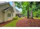 Backyard featuring lush lawn, patio, screened-in porch, and mature trees at 3522 Estates Landing Nw Dr, Kennesaw, GA 30144