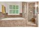Beautiful primary bathroom featuring a soaking tub, large windows, and shower at 3522 Estates Landing Nw Dr, Kennesaw, GA 30144