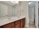 Well-lit bathroom with a double sink vanity and wood cabinets at 3522 Estates Landing Nw Dr, Kennesaw, GA 30144