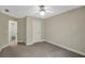 Neutral bedroom featuring carpet, a ceiling fan and white doors leading to another room at 3522 Estates Landing Nw Dr, Kennesaw, GA 30144
