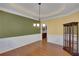 Elegant dining area with hardwood floors, wainscoting, and a view to an eat in kitchen at 3522 Estates Landing Nw Dr, Kennesaw, GA 30144