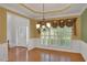 Formal dining room with decorative window treatments, wainscotting, and a chandelier at 3522 Estates Landing Nw Dr, Kennesaw, GA 30144