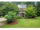 Attractive brick home with a well-manicured lawn and mature trees providing shade at 3522 Estates Landing Nw Dr, Kennesaw, GA 30144
