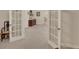 Hallway with french doors and a view to a bedroom with ample natural light at 3522 Estates Landing Nw Dr, Kennesaw, GA 30144