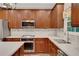 This well-lit kitchen is equipped with stainless steel appliances, white countertops, and wooden cabinets at 3522 Estates Landing Nw Dr, Kennesaw, GA 30144
