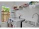Bright laundry room with new appliances, sink, folding counter, and ample storage space at 3522 Estates Landing Nw Dr, Kennesaw, GA 30144