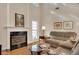 Bright living room featuring a fireplace, hardwood floors, and a comfortable seating area at 3522 Estates Landing Nw Dr, Kennesaw, GA 30144