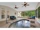 Bright sunroom features a heated pool with a stone waterfall and ample seating at 3522 Estates Landing Nw Dr, Kennesaw, GA 30144