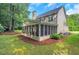 Large screened porch on the back of a two-story home with mature landscaping and fresh mulch at 3522 Estates Landing Nw Dr, Kennesaw, GA 30144