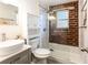 Bathroom featuring brick wall accent, updated vanity, and glass enclosed shower at 40 Daniel Se St # 1, Atlanta, GA 30312
