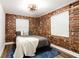 Bedroom featuring brick walls, hardwood floors, a modern ceiling fan, and plenty of natural light at 40 Daniel Se St # 1, Atlanta, GA 30312