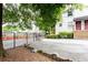 Rear exterior of apartment complex with fenced parking area and landscaping at 40 Daniel Se St # 1, Atlanta, GA 30312