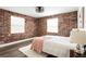 Inviting bedroom featuring exposed brick wall, neutral color palette and stylish decor at 40 Daniel Se St # 1, Atlanta, GA 30312