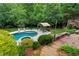 Backyard showcasing a pool, hot tub, pavilion, and a deck with stairs, all surrounded by lush greenery at 209 Breckenridge Ct, Canton, GA 30115