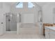 Bright bathroom features a soaking tub, glass-enclosed shower, and natural light from above windows at 209 Breckenridge Ct, Canton, GA 30115