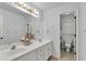 Bathroom with double sink vanity, large mirror with vanity lighting, and separate toilet room at 209 Breckenridge Ct, Canton, GA 30115