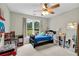 Cozy bedroom with ceiling fan and a large window that allows plenty of natural light at 209 Breckenridge Ct, Canton, GA 30115