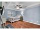 Cozy bedroom with a ceiling fan, neutral walls, and wood-look floors at 209 Breckenridge Ct, Canton, GA 30115