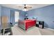 Blue bedroom featuring a large window, ceiling fan, and a simple yet comfortable setup at 209 Breckenridge Ct, Canton, GA 30115