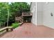A spacious deck with stairs leading to the backyard featuring benches and lush greenery, providing ample space at 209 Breckenridge Ct, Canton, GA 30115