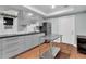 Modern kitchen with gray cabinetry, stainless steel appliances, and a center island for food preparation at 209 Breckenridge Ct, Canton, GA 30115