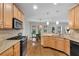 Modern kitchen featuring stainless steel appliances, granite countertops, and hardwood floors, perfect for cooking at 209 Breckenridge Ct, Canton, GA 30115