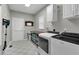 Clean laundry room with modern washer and dryer, storage cabinets, and ample counter space at 209 Breckenridge Ct, Canton, GA 30115