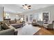 Bright living room with hardwood floors, large windows, and comfortable seating, perfect for entertaining at 209 Breckenridge Ct, Canton, GA 30115