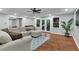 Spacious living room featuring a comfortable sectional sofa and sliding glass doors to the patio at 209 Breckenridge Ct, Canton, GA 30115