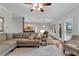 Open-concept living room with hardwood floors, adjacent to the kitchen and dining area, ideal for gatherings at 209 Breckenridge Ct, Canton, GA 30115