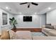 Living room with a large sectional sofa, flat screen tv, and a large potted plant at 209 Breckenridge Ct, Canton, GA 30115