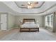 Inviting main bedroom with tray ceiling, cozy carpet, and bright, open windows at 209 Breckenridge Ct, Canton, GA 30115
