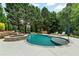 Resort-style backyard with a sparkling pool, integrated hot tub, and lounging area perfect for outdoor entertaining at 209 Breckenridge Ct, Canton, GA 30115